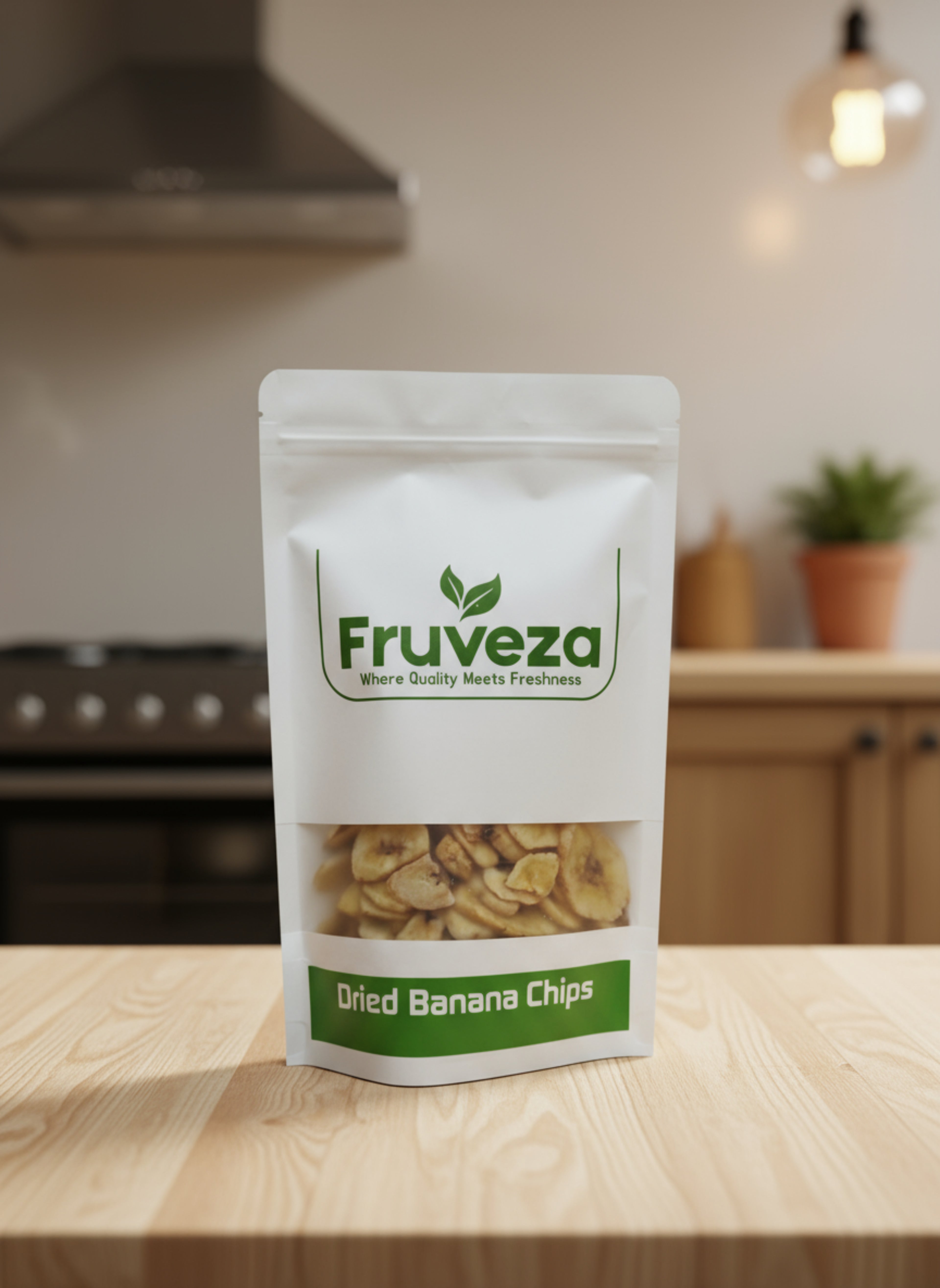 Fruveza dried banana chips packaging on a wooden surface with blurred kitchen background